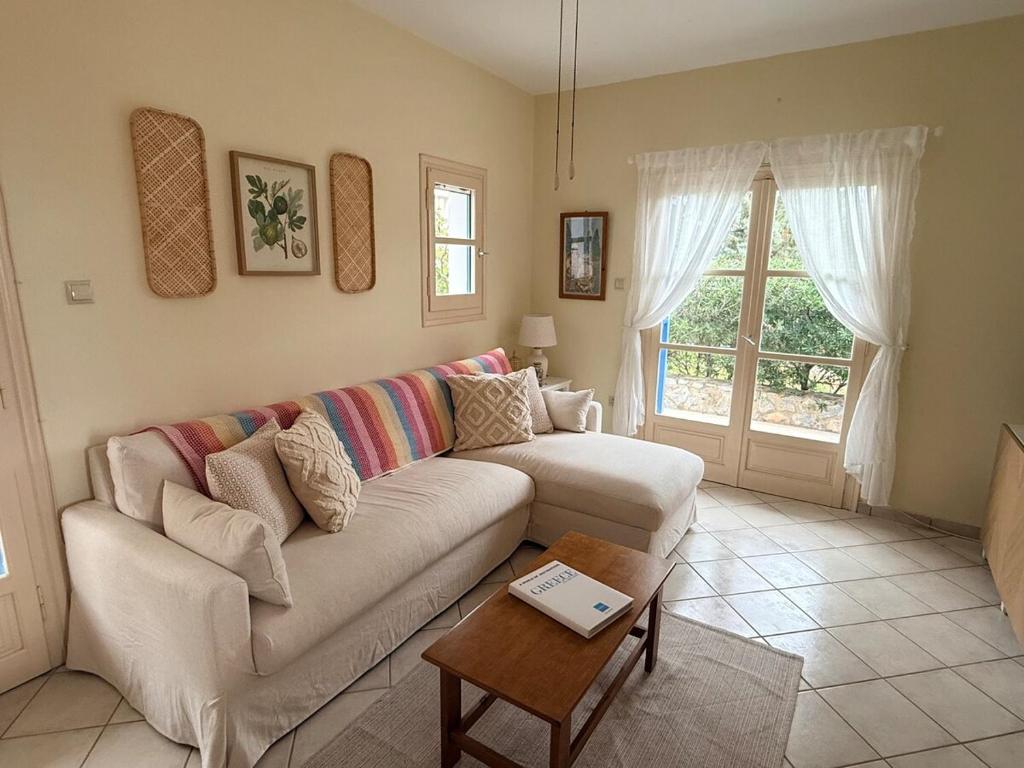 a living room with a couch and a table at Villa Galazia in Megalochori