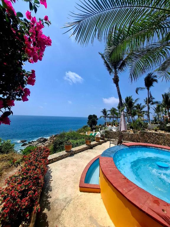 a swimming pool with a view of the ocean at Casa Bella in Puerto Escondido