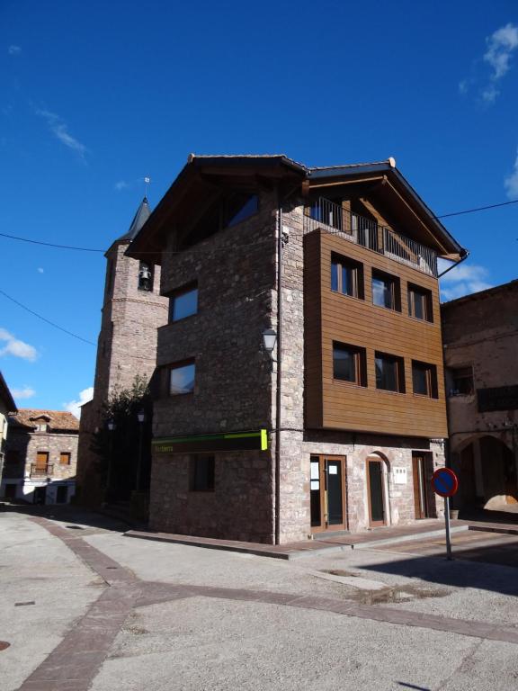 a large brick building on a street at Casa Migalet in Laspaúles