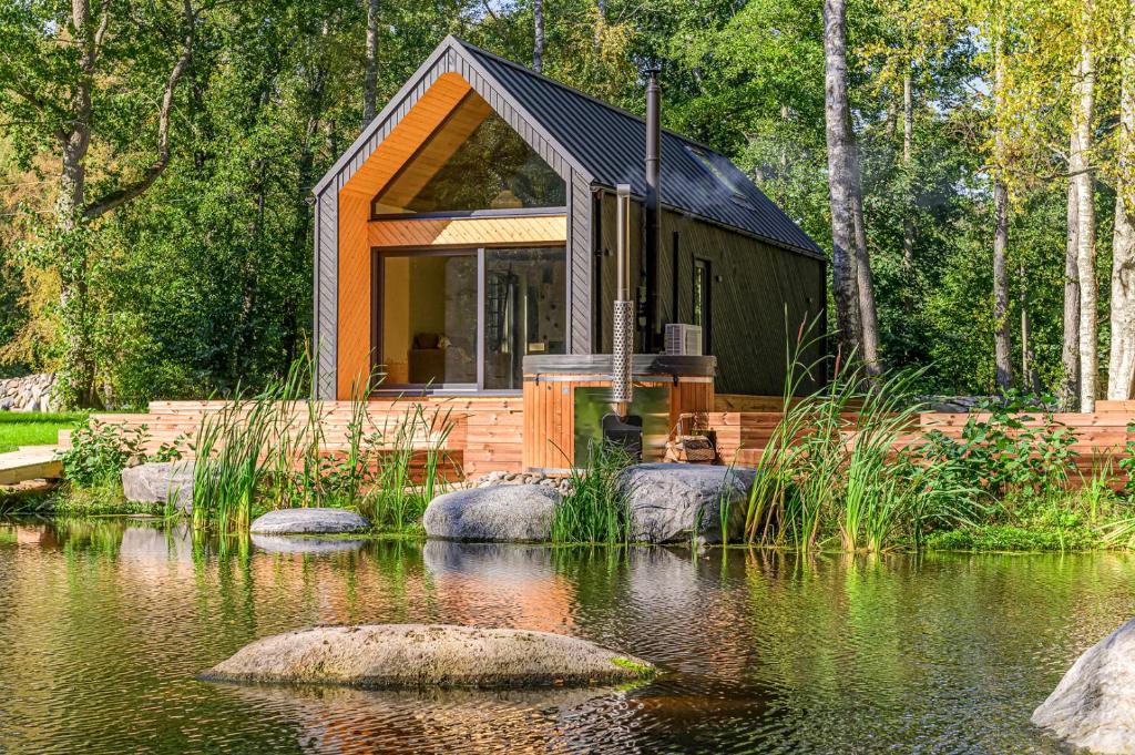 a small cabin in the middle of a pond at CozyEst Meremõisa in Meremõisa