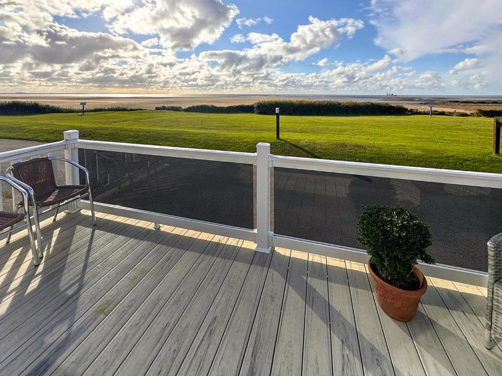 a deck with a chair and a potted plant at Bordeaux in Heysham