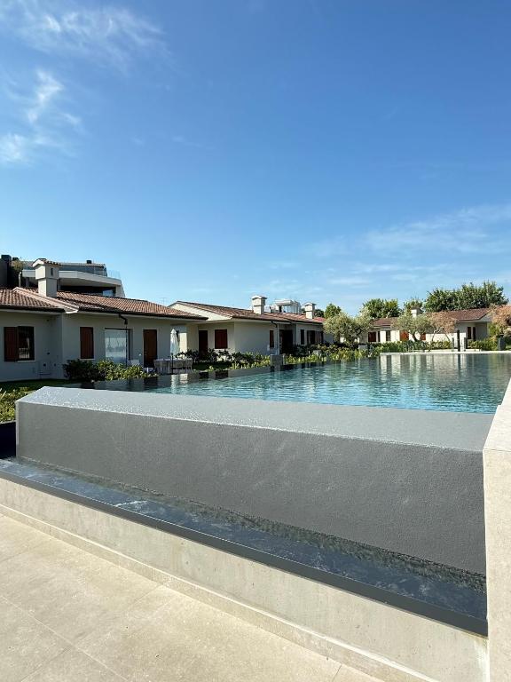 a swimming pool in front of some houses at Bungalow Ville d'Oro in Desenzano del Garda