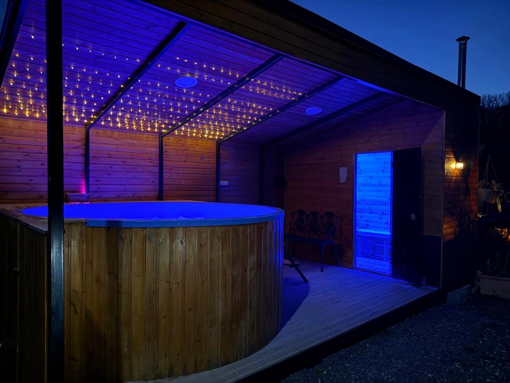a building with a bar with lights on it at Casa David 13D in Nimăeşti