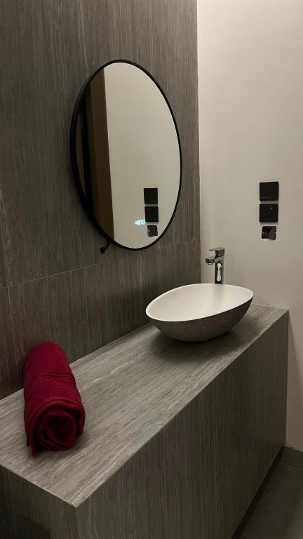a bathroom with a sink and a mirror at محمد هوم in Al Hofuf