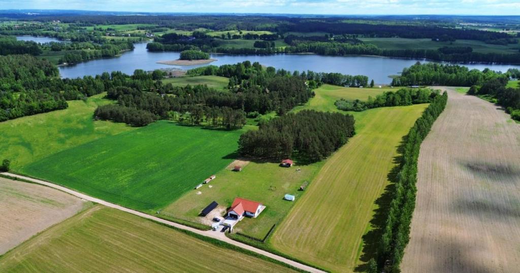 an aerial view of a farm and a lake at Dom Mazury in Langendorf