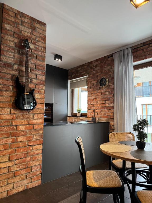 a kitchen and dining room with a brick wall at Sunset Loft in Lubin