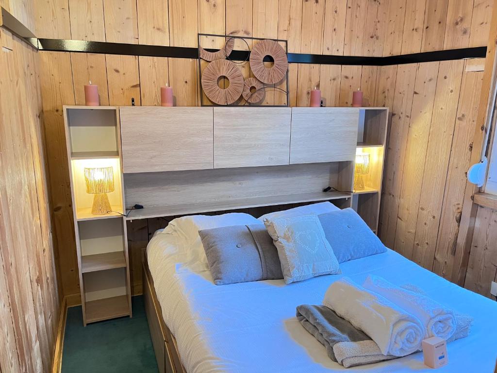 a bedroom with a bed with two pillows on it at Logicoeur in Gérardmer