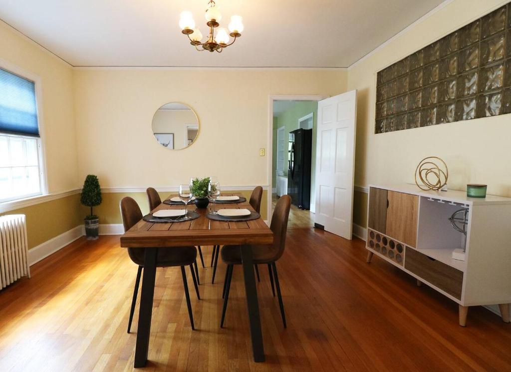 a dining room with a wooden table and chairs at Lofty Elegant Home • Downtown Princeton • 3BR in Princeton