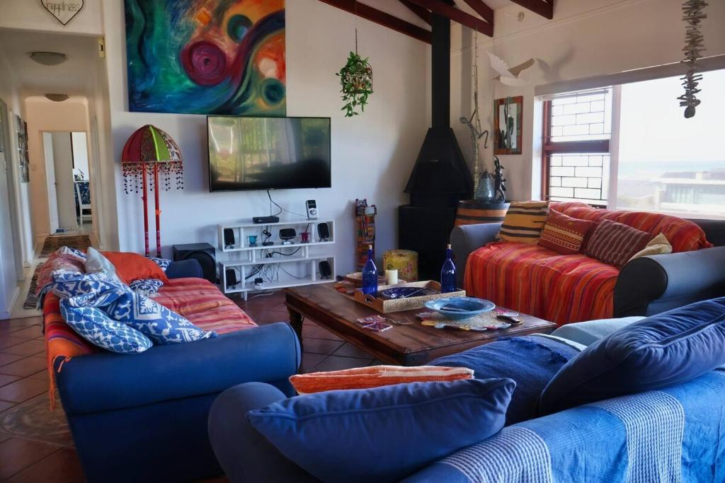 a living room with two couches and a table at The Wilderness Way in Wilderness