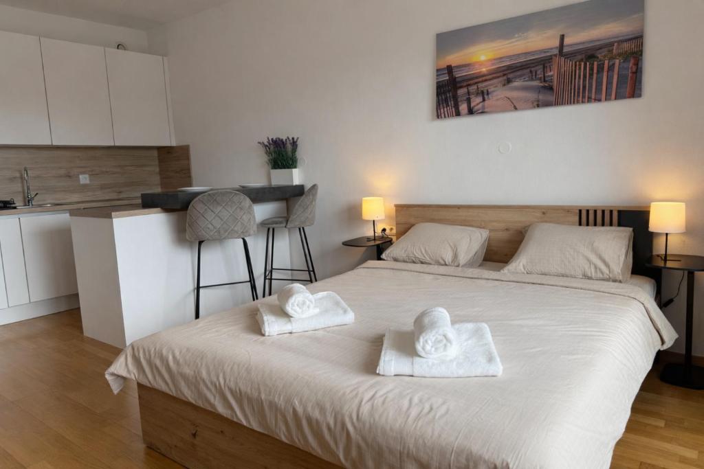a bedroom with a bed with two towels on it at Pipanova Cosy Nest with Balcony & Free Parking in Ljubljana