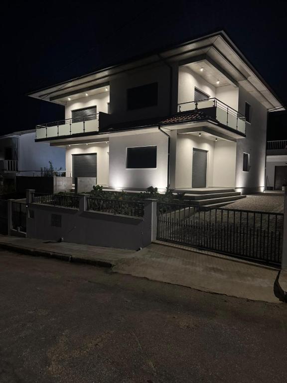 a large white house with lights on it at night at Casa do Paçô - Cabeceiras de Basto in Cabeceiras de Basto