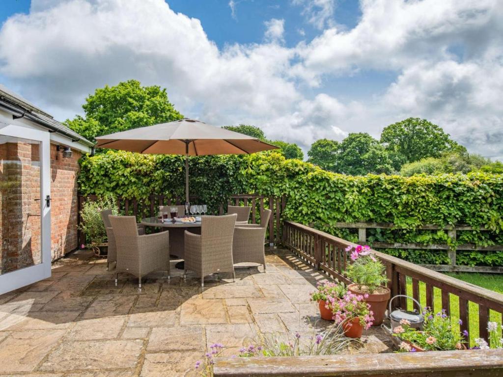 a patio with a table and an umbrella at 3 Bed in Wareham oc-dc129 in Turners Puddle