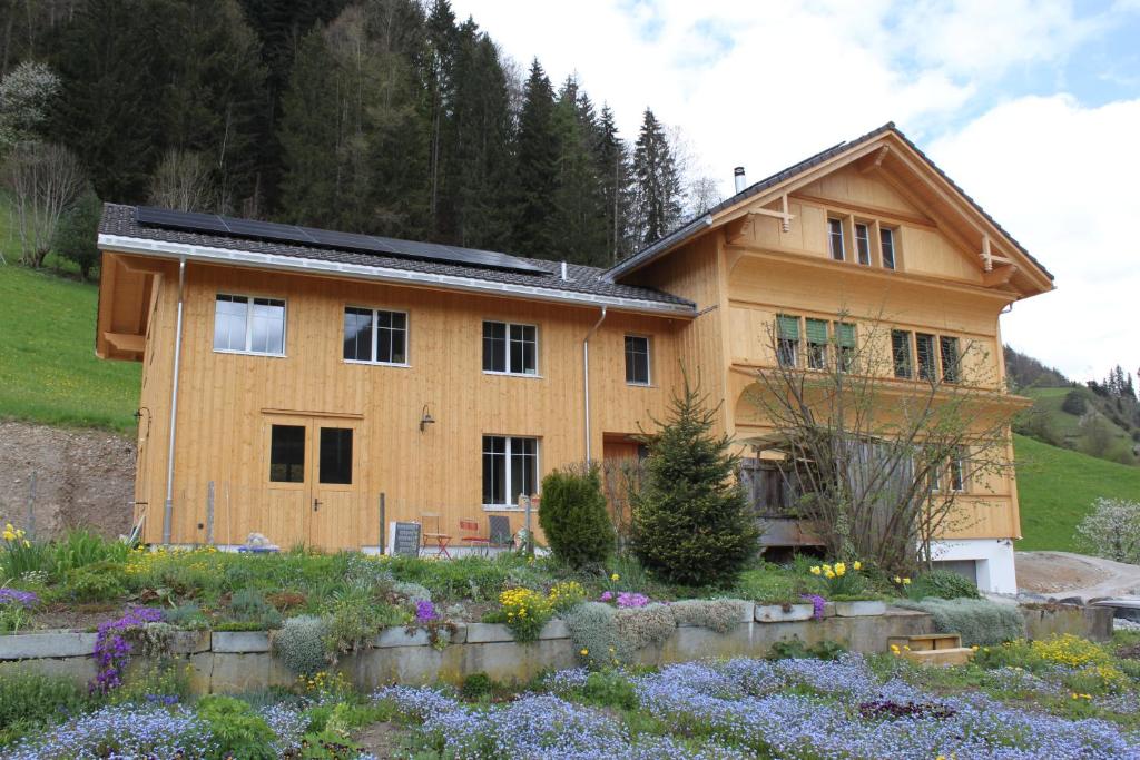 a house with a garden in front of it at Chesa Clavazzin in Brunnadern