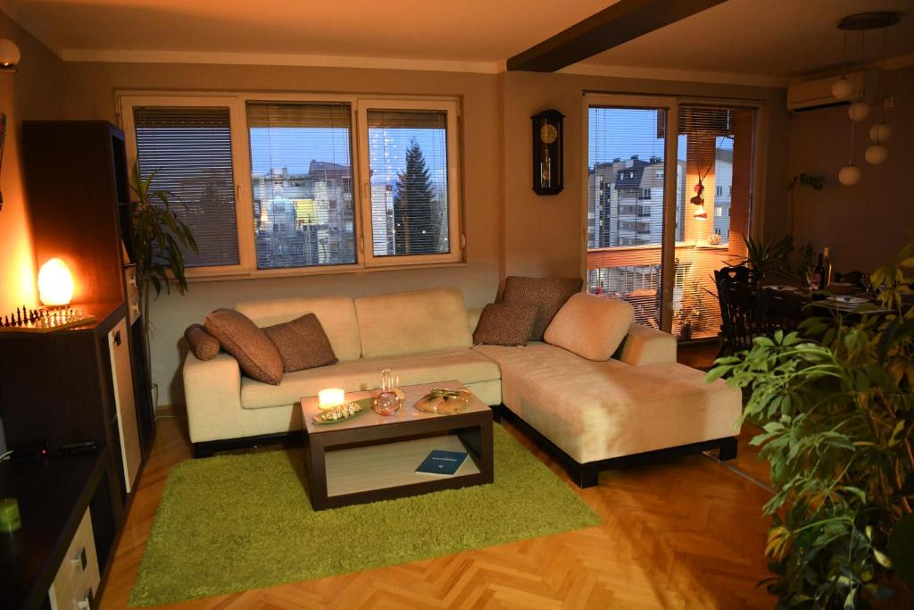 a living room with a couch and a table at Mustache 3 Room Apt City Center in Bitola
