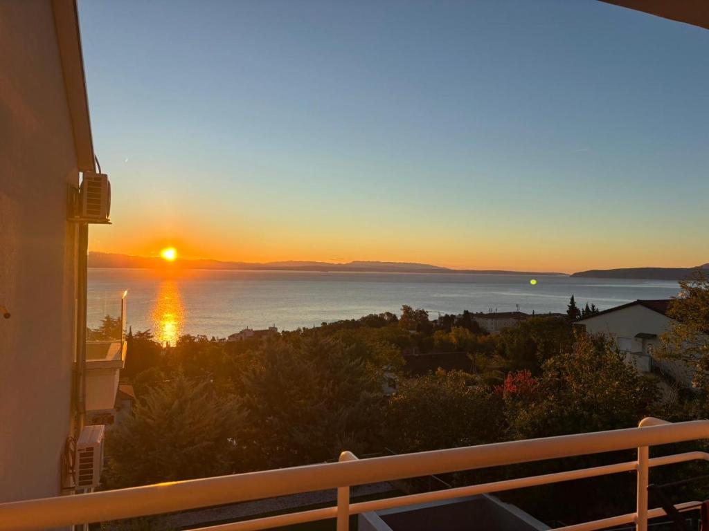 a sunset from the balcony of a house at SeaView Lovran in Lovran
