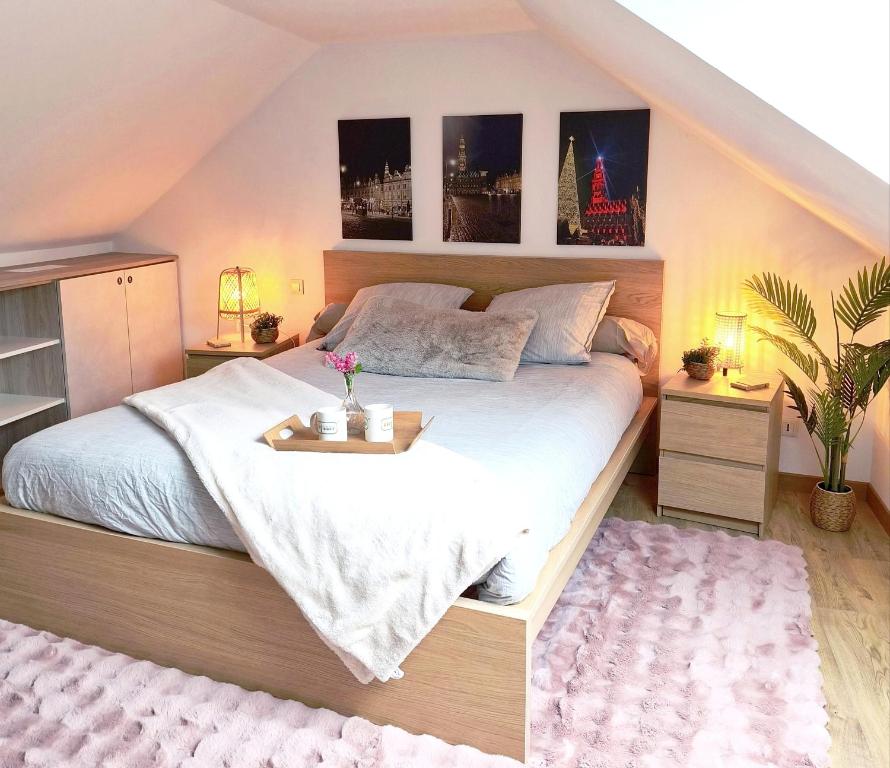 a bedroom with a bed with a tray on it at Trésor de Beaurains in Beaurains