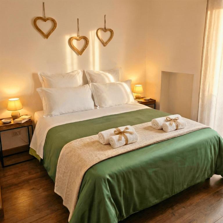 a bedroom with a large bed with two towels at Melo Accommodations in Bari