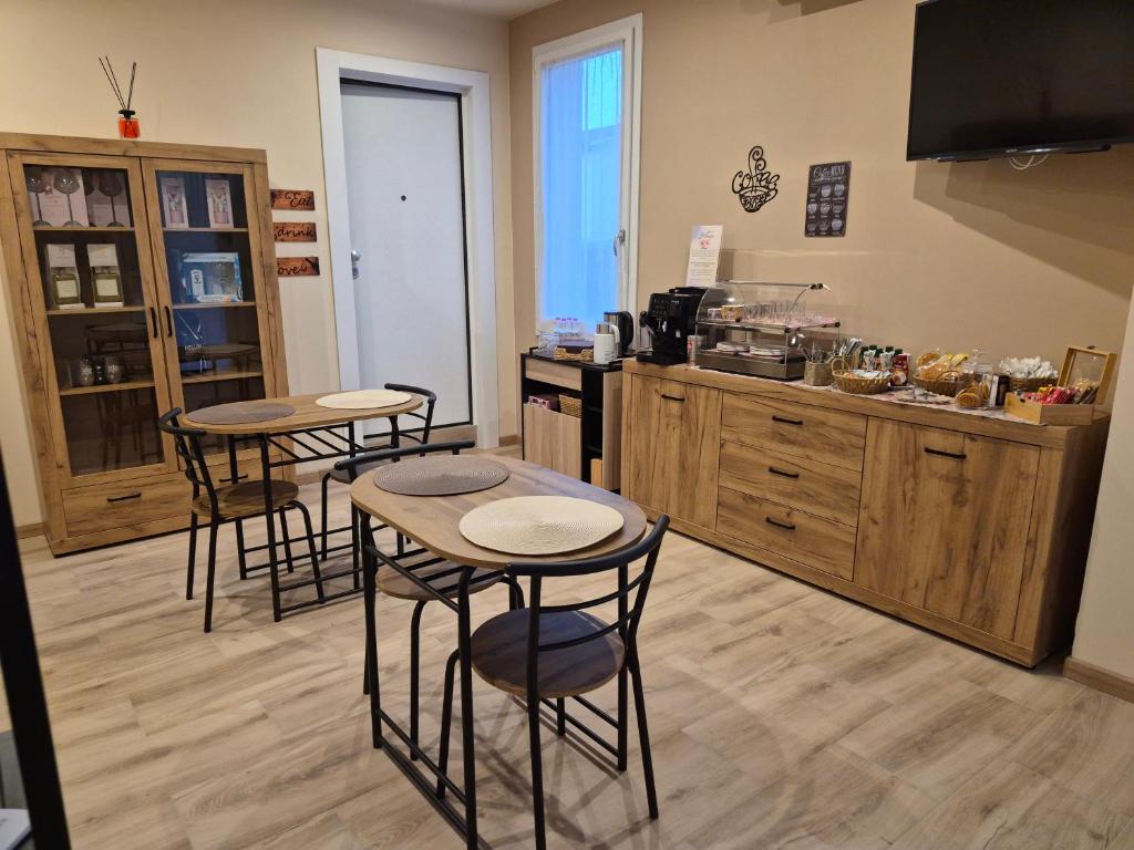a kitchen with three tables and a counter at Hibiscus Affittacamere - rooms&more in Stanghella