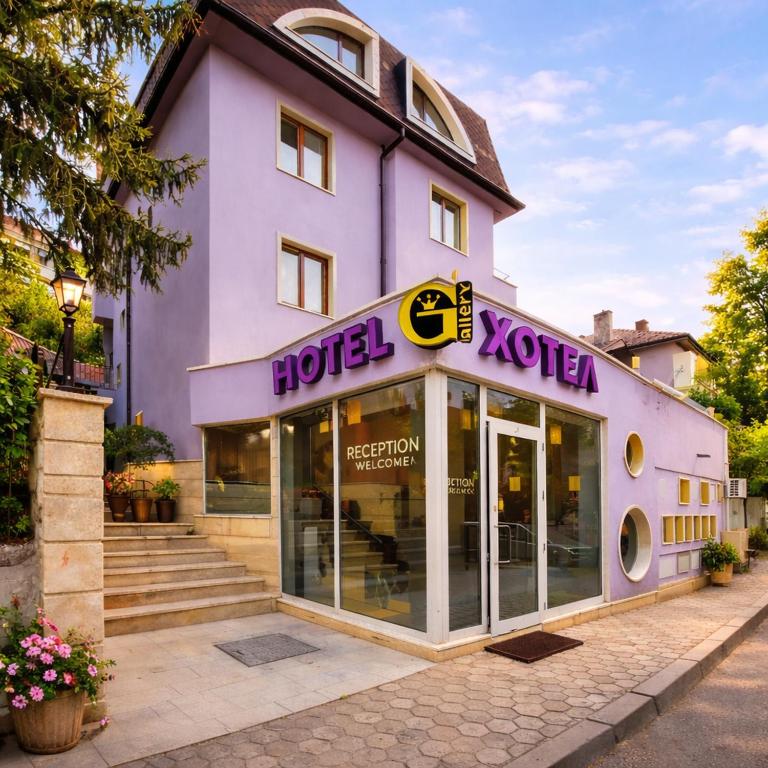 a purple building with a hotel kotzu on it at Family Art Hotel Gallery in Pleven