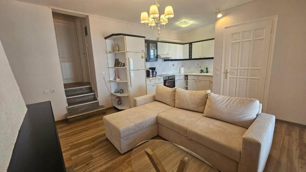 a living room with a couch and a kitchen at PELION HORIZON houses in Agios Ioannis Pelio