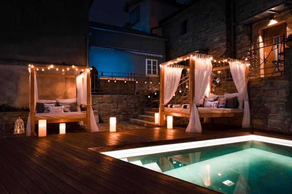 a backyard with a swimming pool and a bed and a pool at Istrian Perfect Life in Šmarje