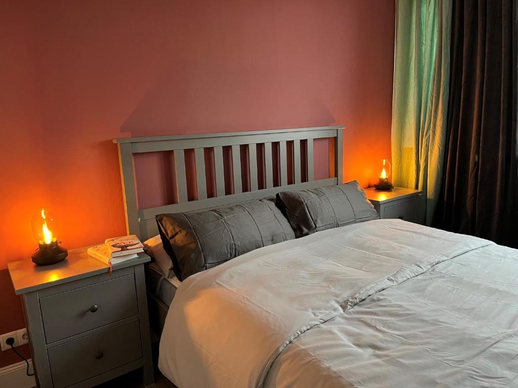 a bedroom with a large bed and two lamps at Justs Place in Garding