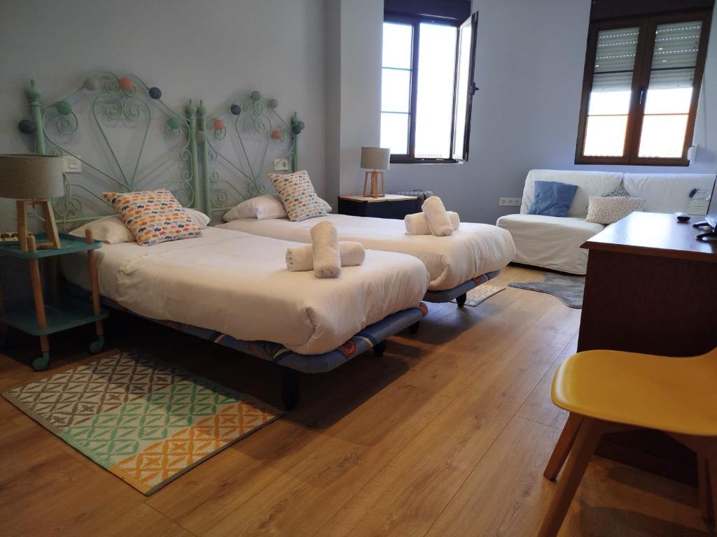 a room with two beds and a couch at R2R - Apartamento cerca del mar - 14A12 in Lastres