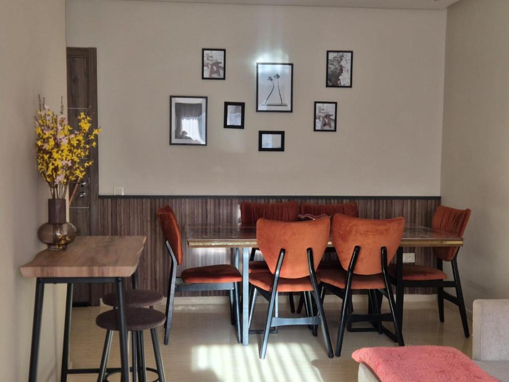 a dining room with a wooden table and chairs at CaSa FAMILY HOUSE in Casablanca