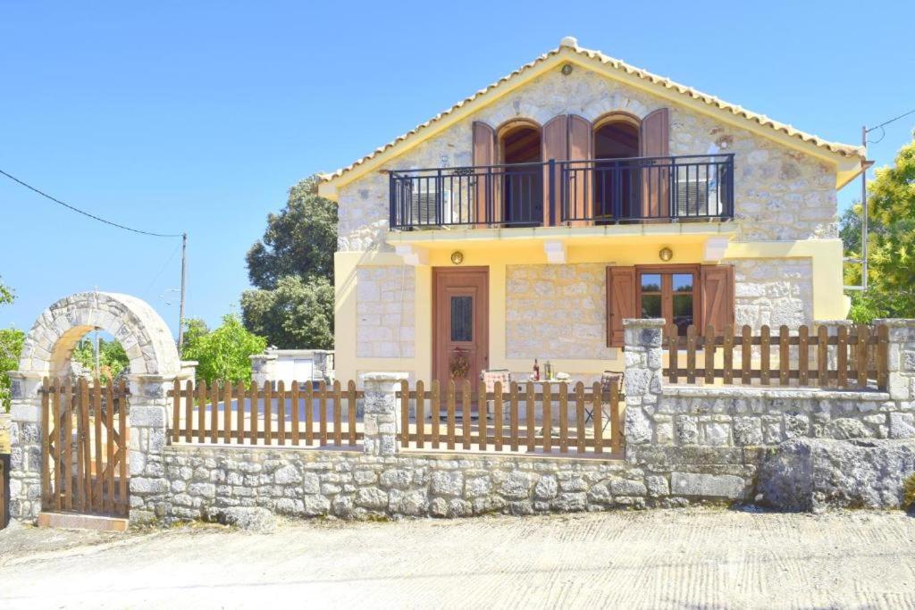 a house with a wooden fence in front of it at Villa Araklis, Ithaca in Anoyí