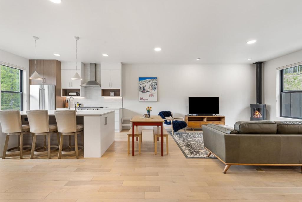 a kitchen and living room with a couch and a table at Bridger Bowl - Crosscut Hideaway in Bozeman