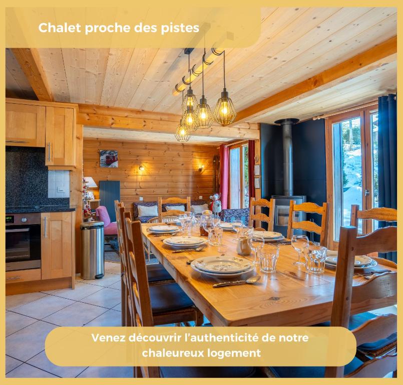 a dining room with a large wooden table with chairs at Olaf Chalet IT5 I Les Gets in Les Gets