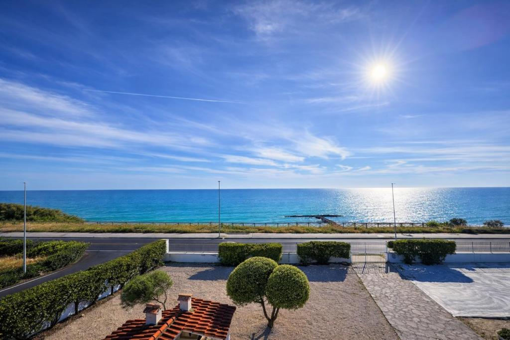 a patio with a view of the ocean at Edo House Anzio - Beachfront - Fronte Mare - Affittacamere - Private Parking in Anzio