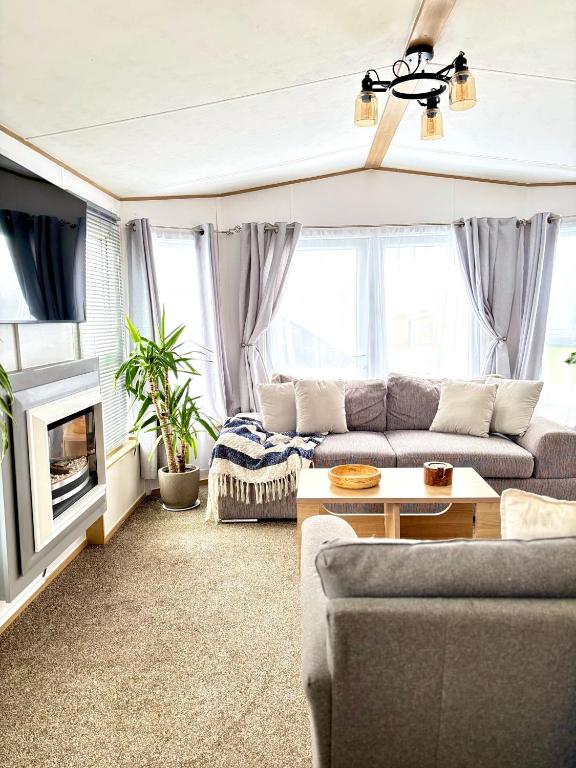 a living room with a couch and a table at Seven Bays Hideaway in Saint Merryn