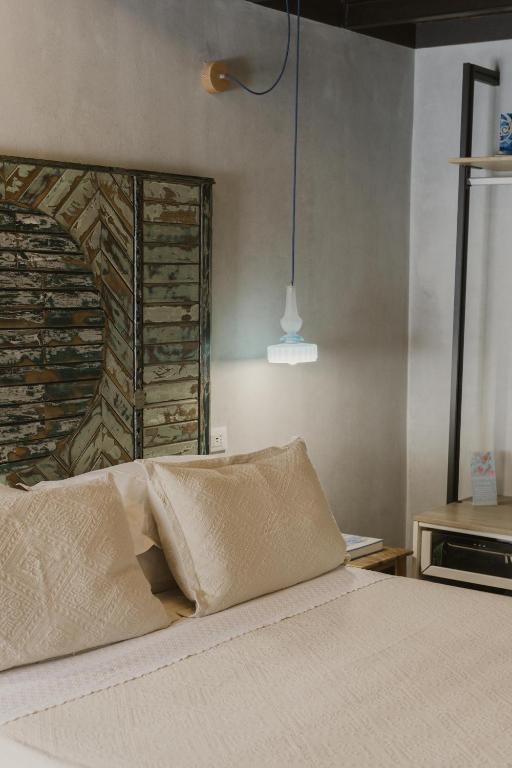 a bed with two pillows on it in a room at Al Cortile Del Seminario in Cefalù