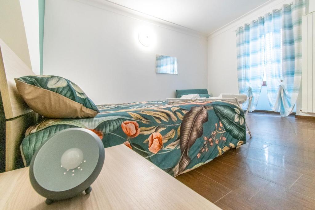 a bedroom with a bed and a couch at ANTONELLI Apartment L'AQUILA in LʼAquila