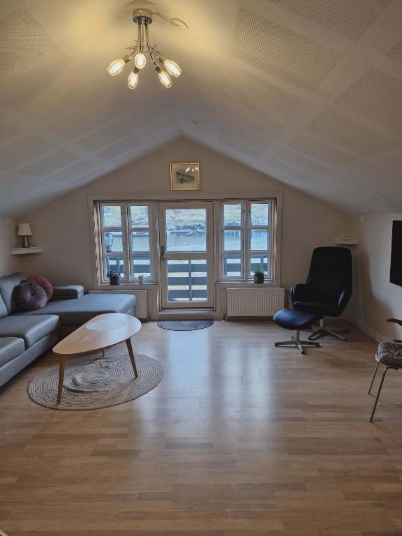 a living room with a couch and a table at Mariustova close to the airport in Ryggur