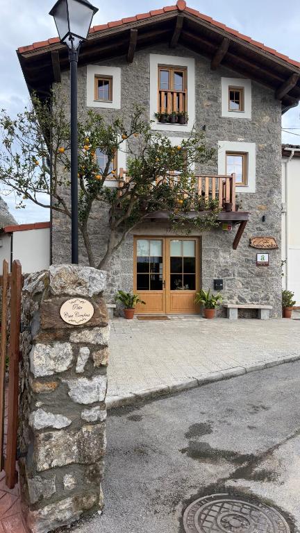 a stone house with a street light in front of it at Casa Candina in Castro-Urdiales