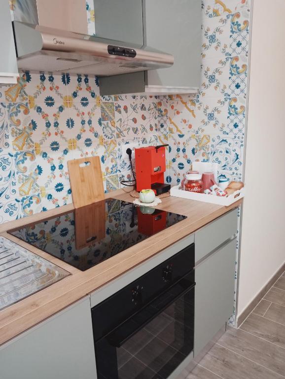 a kitchen with a counter with a stove top oven at La casa di Clizia in San Marco Evangelista