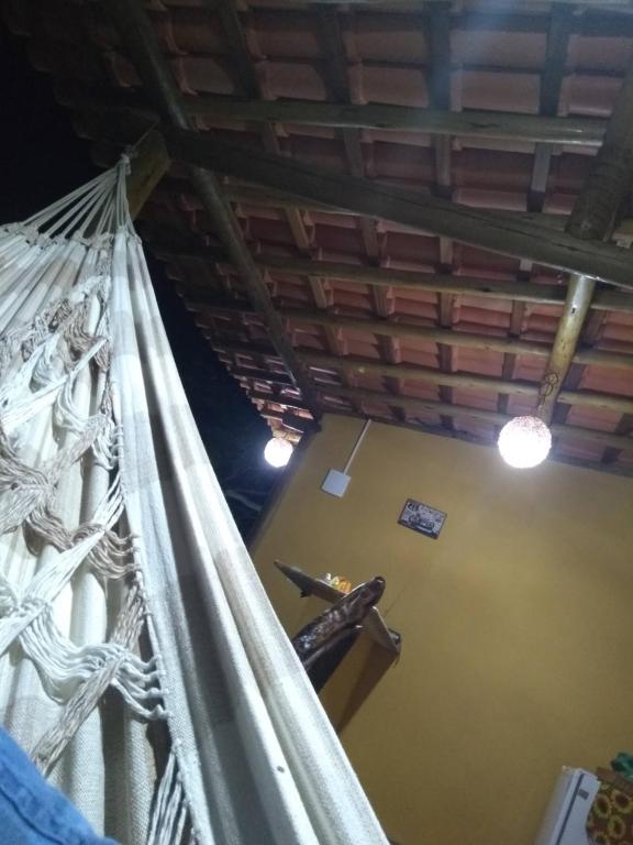 a view from the balcony of a room with a curtain at Acampamento Dos Frangos in Itabuna