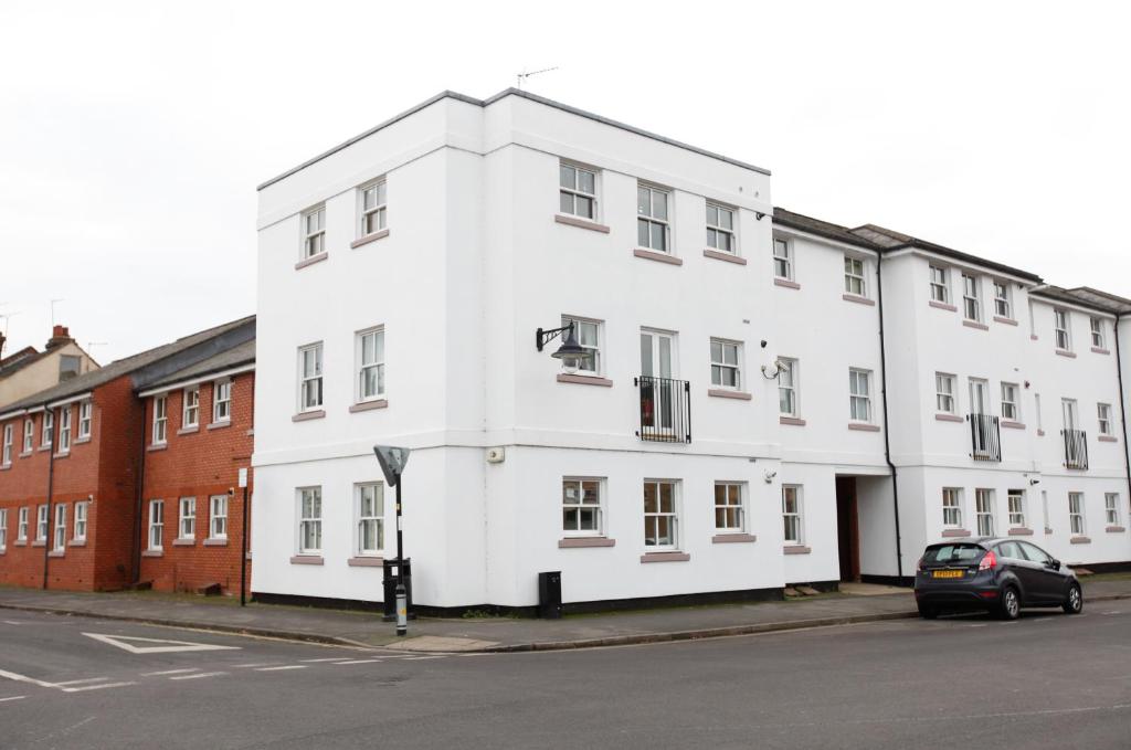 a white building on the side of a street at Leamington Spa Apartments in Leamington Spa