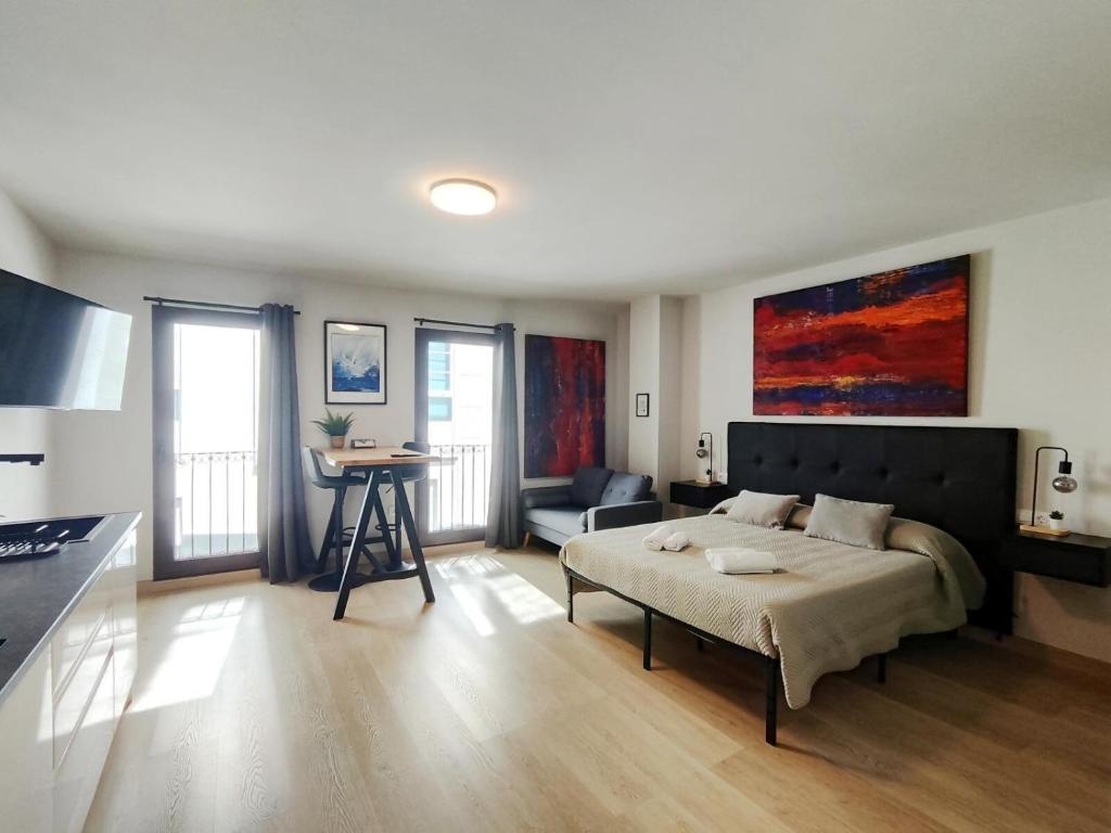 a bedroom with a bed and a table in it at Suite imperial Muralla de Lugo 2.2 in Lugo