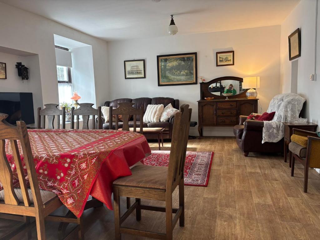 a living room with a table and chairs and a couch at Diamond View House in Letterfrack