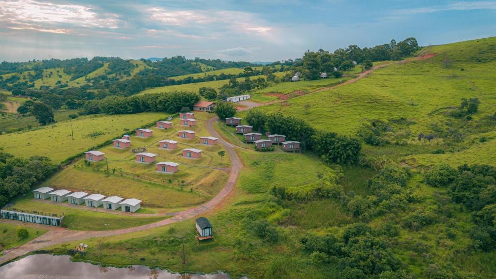 an aerial view of a farm with tents on a hill at Monakó Cabanas in Bragança Paulista