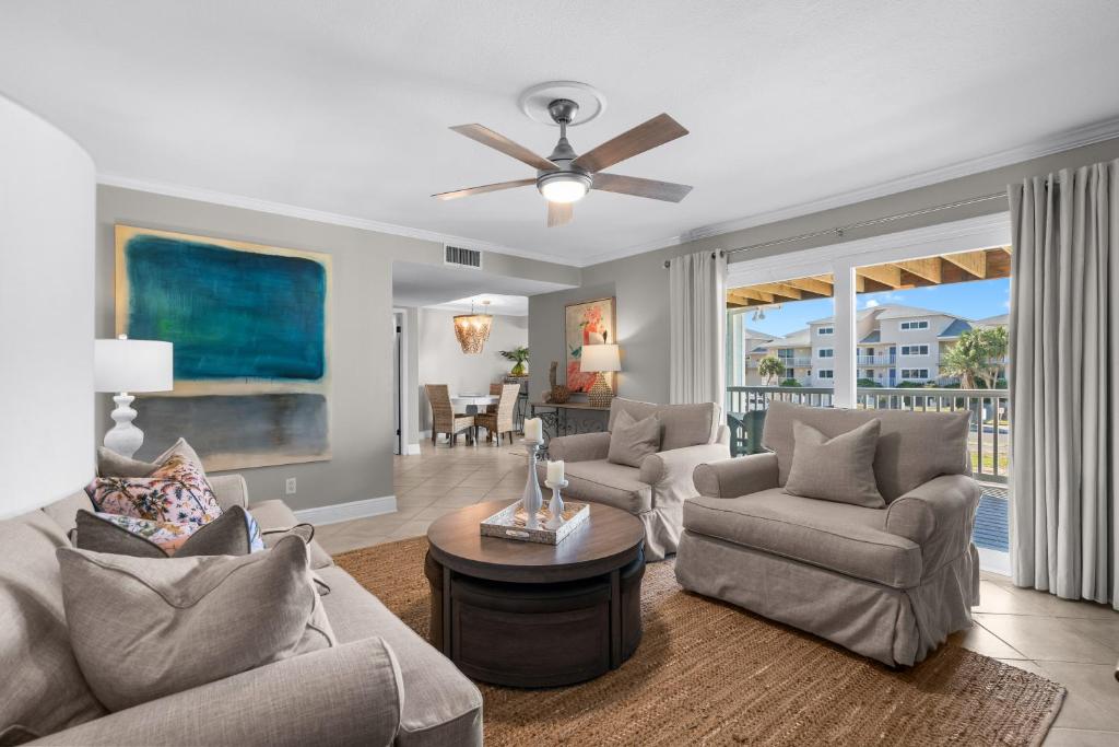 a living room with couches and a ceiling fan at Boardwalk Unit A4 in Pensacola Beach