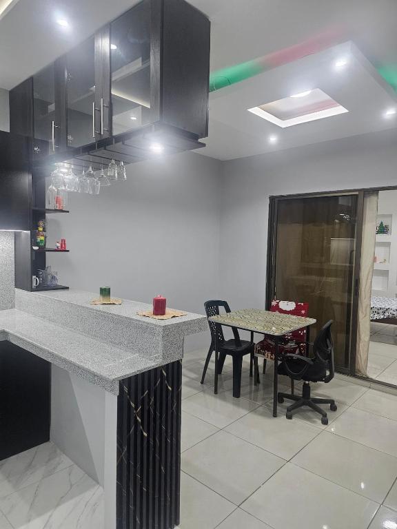 a kitchen with a counter and a table and chairs at Newly Opened Mini Suite in Manta
