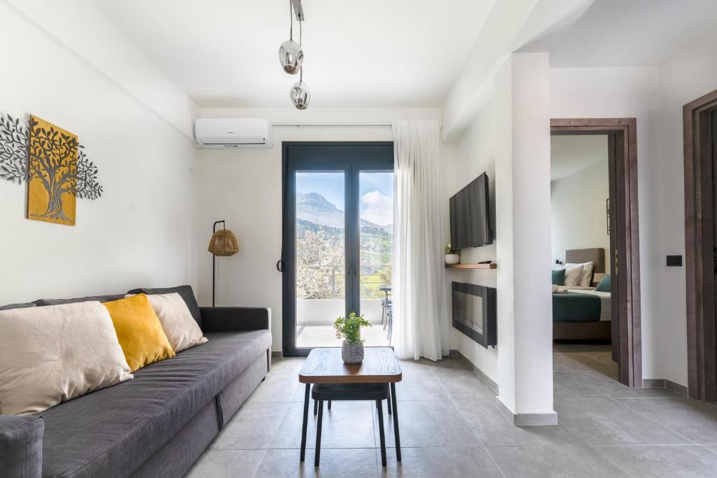 a living room with a couch and a table at AORA Asites Mountain View in Kato Asites