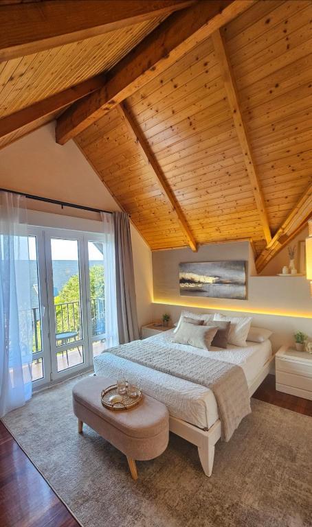 a bedroom with a large bed and a large window at VILLA PANGEA Habitaciones Boutique - Camino del Norte - Castro Urdiales in Castro-Urdiales