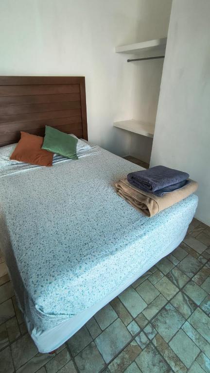 a bedroom with a bed with towels on it at El Cedralito in Mérida