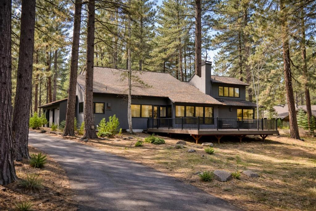 a house in the woods with a driveway at East Meadow 017 in Black Butte Ranch
