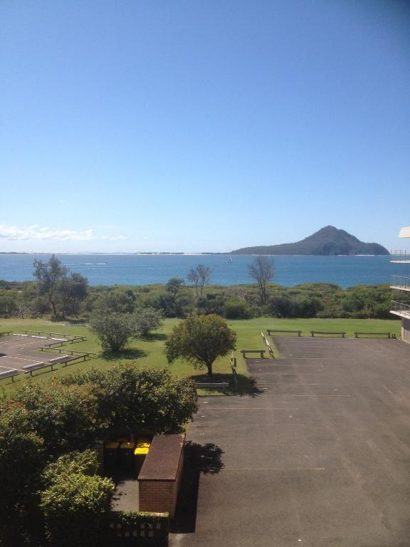 a park with benches and a view of the water at Shoal Bay Water Views, 1 night stays available in Nelson Bay